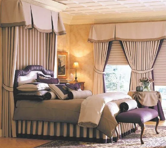 Elegant bedroom with custom bedding, drapery, and an upholstered bench