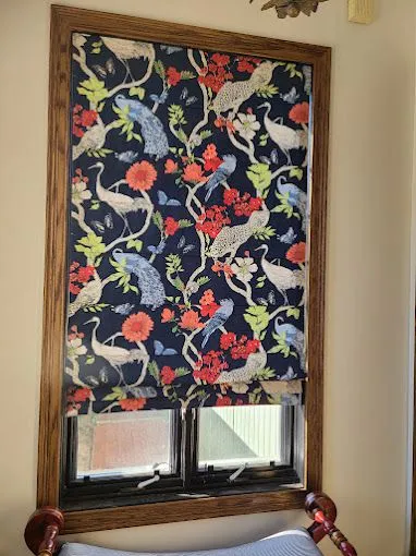 A close-up of colorful custom drapery fabric with a bird pattern